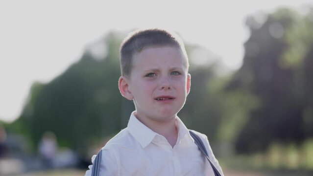 sad boy crying in the park in summer 4k