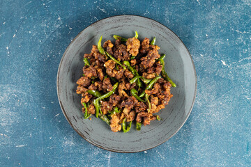 Stir Fried Green Chilli Chicken Dry served in plate isolated on navy background top view of bangladeshi food
