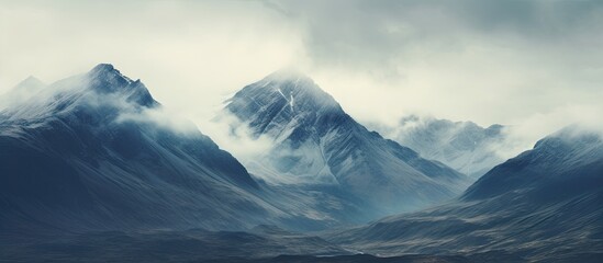 Dramatic skies and high peaks create a vast mountain scene with an incredible copy space image