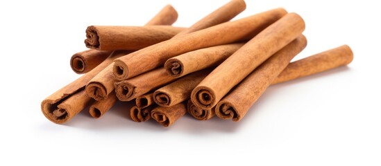 A copy space image featuring cinnamon sticks set against a clean white background