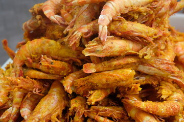 Delicious fried sea prawns on a container. Shrimp or prawns is a variety of seafood that is popular in Indonesia. Indonesian food. Udang goreng. 