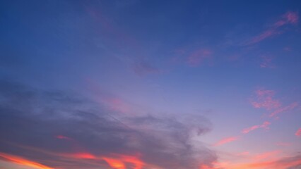 A vivid sunset with a sky that transitions from deep blue at the top to soft pink and orange near...