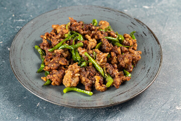 Stir Fried Green Chilli Chicken Dry served in plate isolated on grey background side view of bangladeshi food