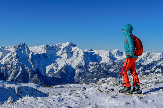 Woman in warm clothing looking at Spitzmauer and Grosser Priel from Pyhrner Kampl, Totes Gebirge, Upper Austria, Austria