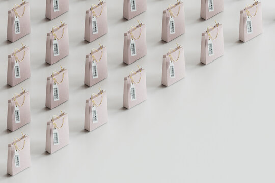 Minimalist shopping bags arranged in row against gray background