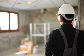 Construction worker looking at site under renovation