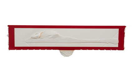 Narrow rectangular white paper with red frame torn from a box packaging