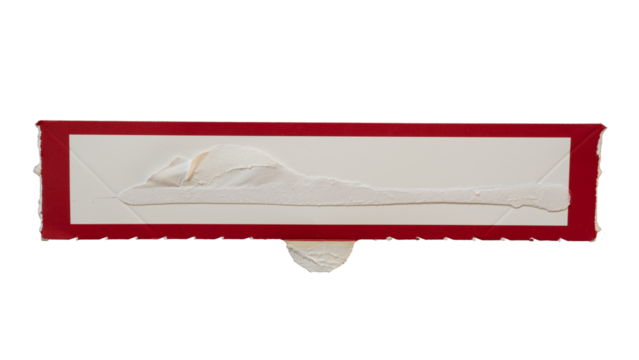 Narrow rectangular white paper with red frame torn from a box packaging