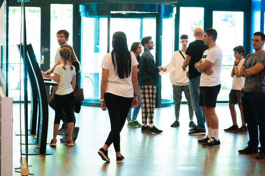 People standing in lobby of indoor skydiving center