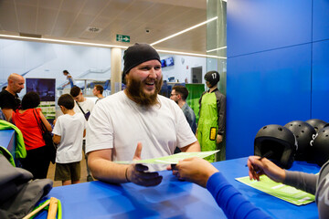 Happy man receiving certificate at indoor skydiving center