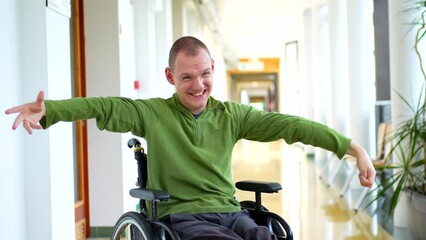 Portrait of a happy man in wheelchair with physical disability in the university - Powered by Adobe