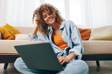 Smiling Woman Typing on Laptop, Enjoying Freelance Job at Home