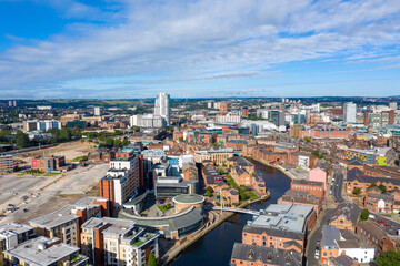 Aerial photo of the Leeds City Centre taken from the area known as The Leeds Dock on a bright sunny summers day showing apartments on either side of the Leeds and Liverpool canal