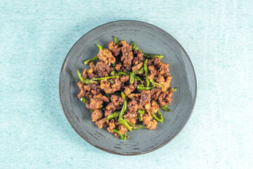Stir Fried Green Chilli Chicken Dry served in plate isolated on sky background top view of bangladeshi food