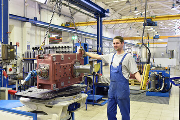 modern mechanical engineering - gear manufacturing factory - assembly by young workers