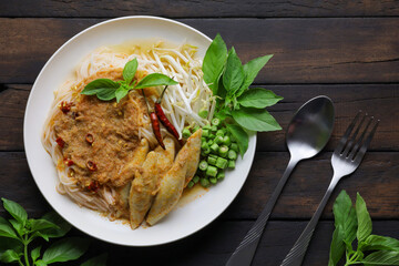 Rice noodles in fish curry sauce with vegetables ,Noodles with fish chili paste. Traditional Thai food Vermicelli served with vegetables isolated on white background, original food concept.