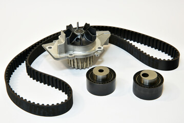 The timing belt, rollers and water pump stands on a white background