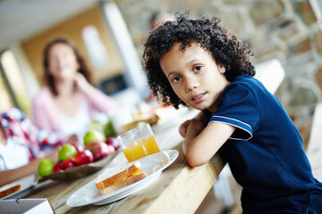 Child, portrait and family table with sandwich for eating, growth and lunch time with meal. Young...