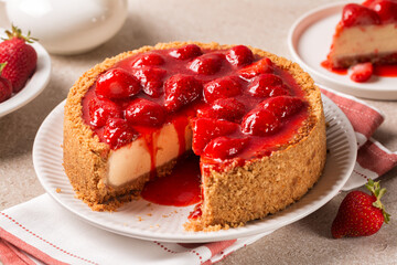 Breakfast with classic baked cheesecake  with a strawberry topping sauce. Homemade fruit pie.