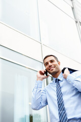 Phone call, walking or happy businessman by outdoor building talking for conversation or deal communication. News, proud banker and financial advisor networking for investment, negotiation or chat