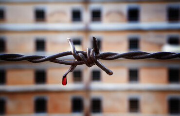Torn iron fences with blood on Prison or jail is a building where people are forced