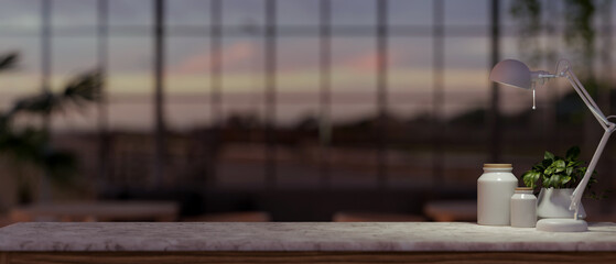 A space for showcasing products on a marble table in a modern, dark building with a large window.