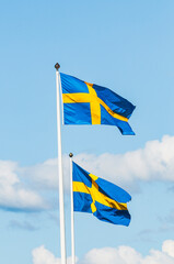 Two Swedish Flags Flying in the Wind
