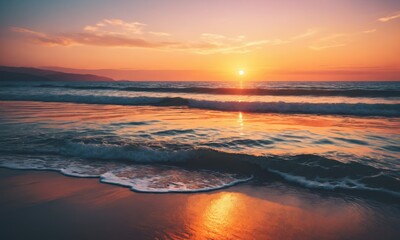 Fototapeta premium Waves crashing on sandy beach at sunset.