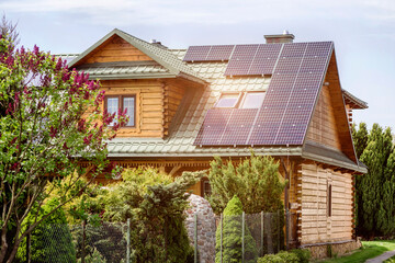 Solar Panel Station on Old House Roof with Wooden Facade and Dormers Windows. Eco Modern Technology...