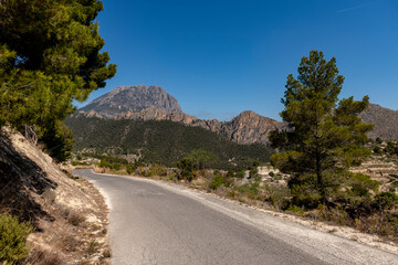 Scenic View Of Mountains and road Against Blue Sky, Alicante, Spain - stock photo