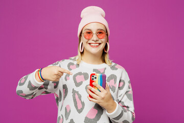 Young happy lesbian woman wear pink animal clothes hold in hand use point index finger on mobile...