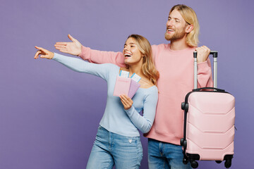 Traveler two friend man woman wear casual clothes hold passport ticket bag isolated on plain purple...