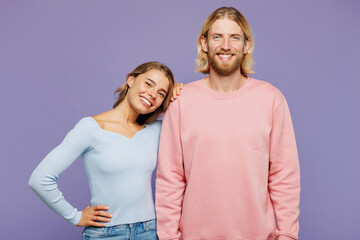 Young smiling couple two friends family man woman wear pink blue casual clothes together girl put...