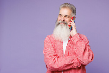 Young elderly bearded gay man 50s years old wears pink shirt casual clothes talk speak on mobile...