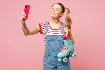 Young woman she wear red t-shirt denim overalls casual clothes hold blue rollers doing selfie shot...