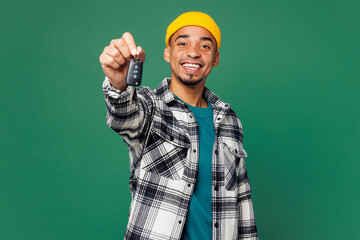 Young smiling happy man of African American ethnicity he wear shirt blue t-shirt yellow hat hold...