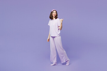 Full body side view young calm woman wear pyjamas jam sleep eye mask rest relax at home walk go...