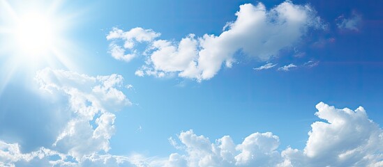 A serene scene of a sunny sky with a high sun position and some sparse clouds ideal for a copy space image