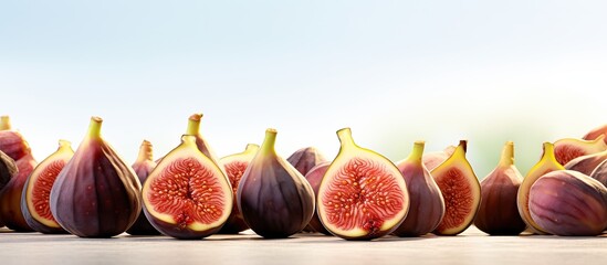 Fresh fig fruits and figs in a cut showcased in a white background with copy space image
