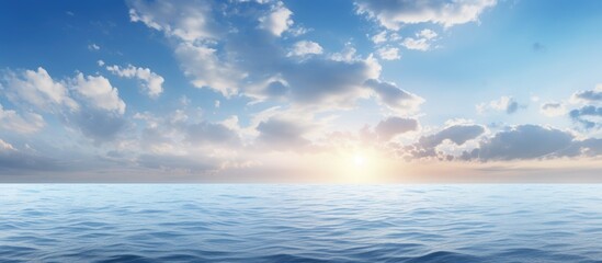 Fototapeta premium The morning sky boasts a vibrant blue hue with white clouds while the deep indigo ocean creates a calming and cool atmosphere ideal as a cold background with copy space above it