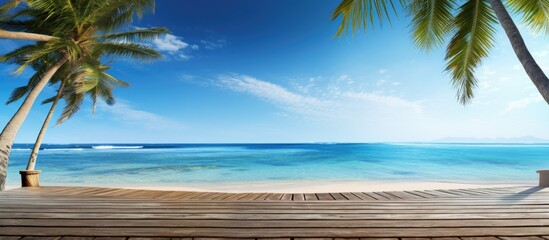 A tranquil beach scene on a sunny day with palm trees and a wooden walkway ideal for a horizontal banner with copy space image