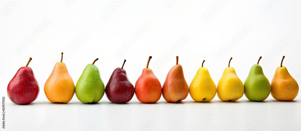 Wall mural colorful ripe pears arranged for display on white background with ample copy space image