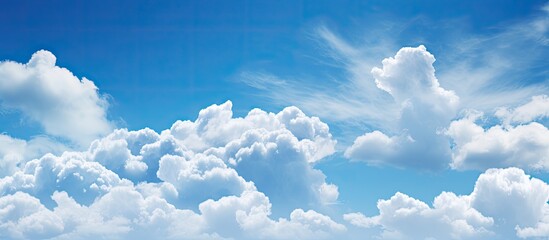 A serene blue sky with fluffy white clouds providing a perfect copy space image - Powered by Adobe