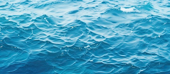 Examining the texture of the blue water in the ocean with a copy space image