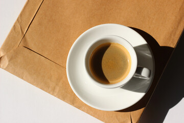 Cup of Coffee on Kraft Paper Parcel with Documents. Business Coffee Break.