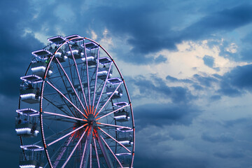 Ferris wheel for panoramic view in amusement park is popular entertaining ride in summer evening