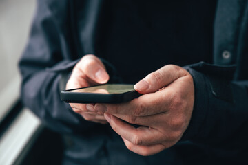 Woman typing text message on mobile phone while riding public transportation bus