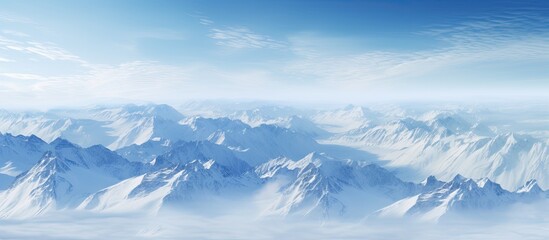 Fototapeta premium Aerial photograph showcasing stunning mountain landscapes with a vast expanse of snow covered peaks and valleys suitable for use as a copy space image