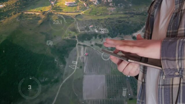 POV of a farmer using digital tablet in the vegetable farm, organic smart farm control by science technology and visual graphic display.