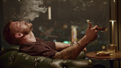 Brutal man smokes cigar. Media. Attractive man with beard smokes cigar coolly. Cinematic cigar...